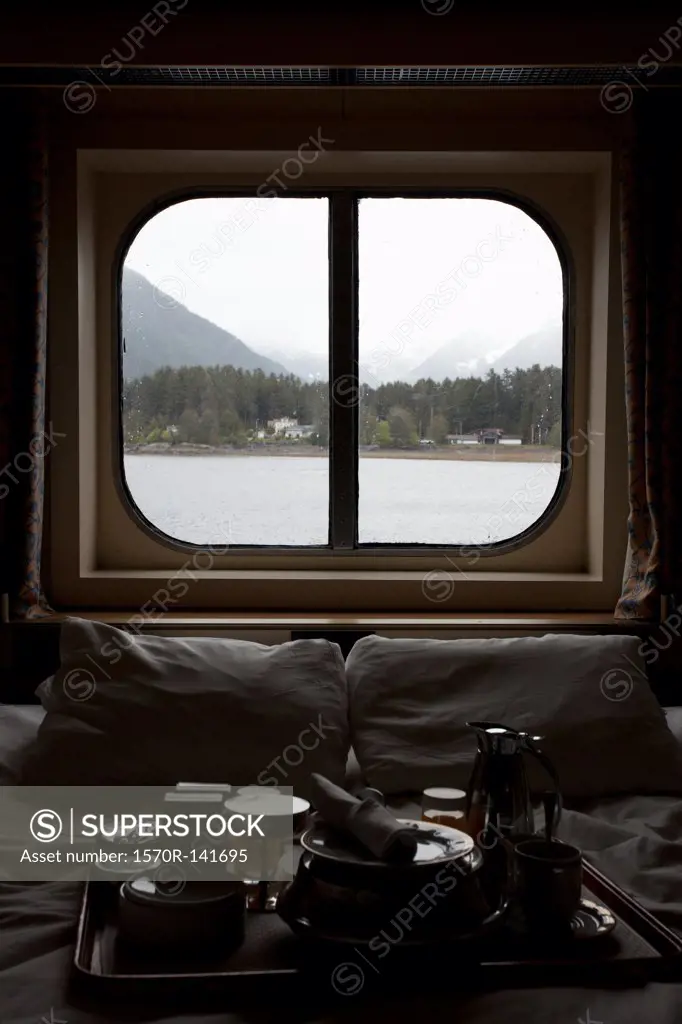 View of Juneau, Alaska thru bedroom window of a passenger ship