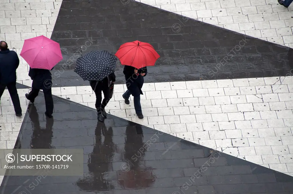 Pedestrians below with umbrellas