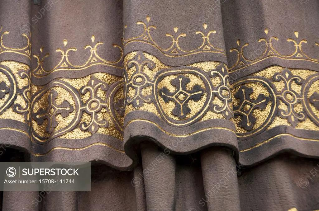 Golden detail of garment on clerical statue of Saint Ansgar