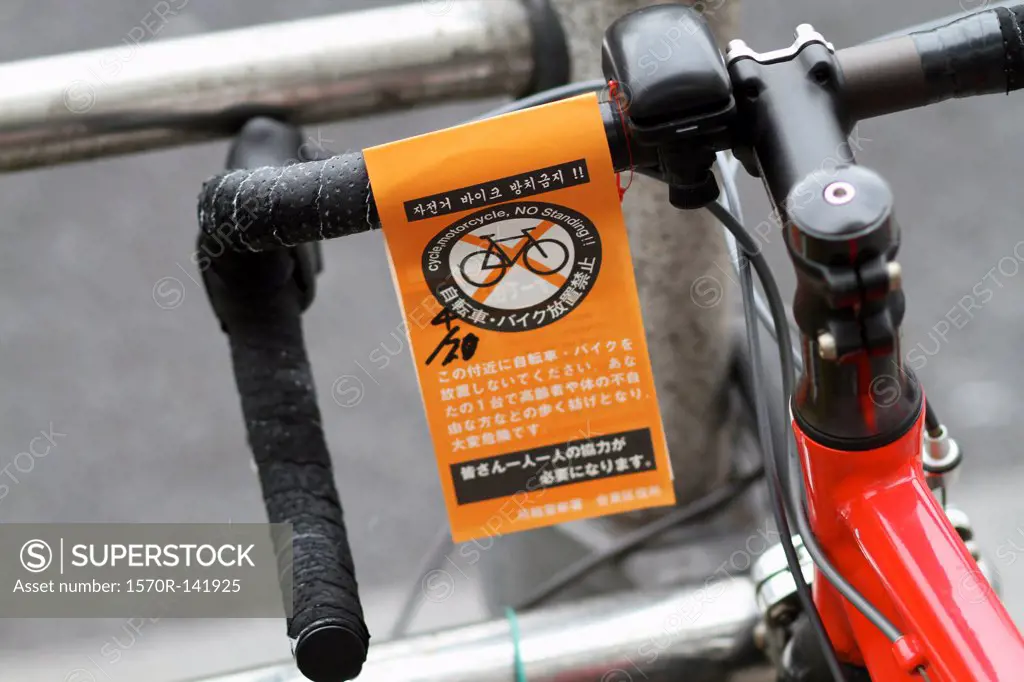 A ""No Standing"" parking ticket for bicycle in English and Japanese
