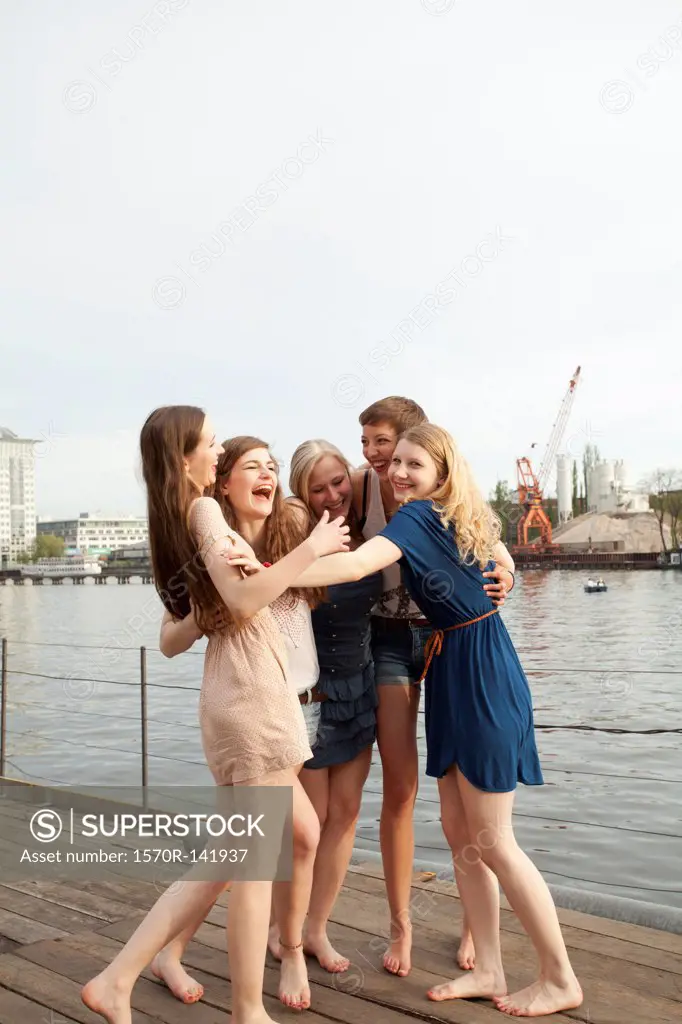 Five female friends embracing and laughing, Spree Rive, Berlin, Germany