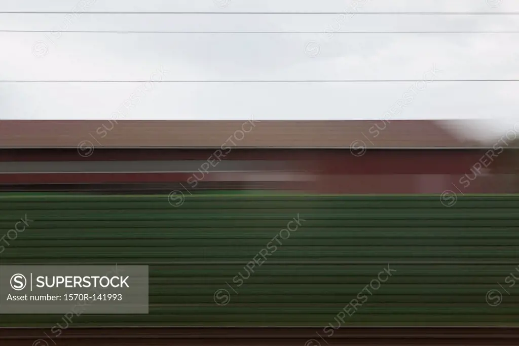 A building and abstract pattern in blurred motion viewed from moving train