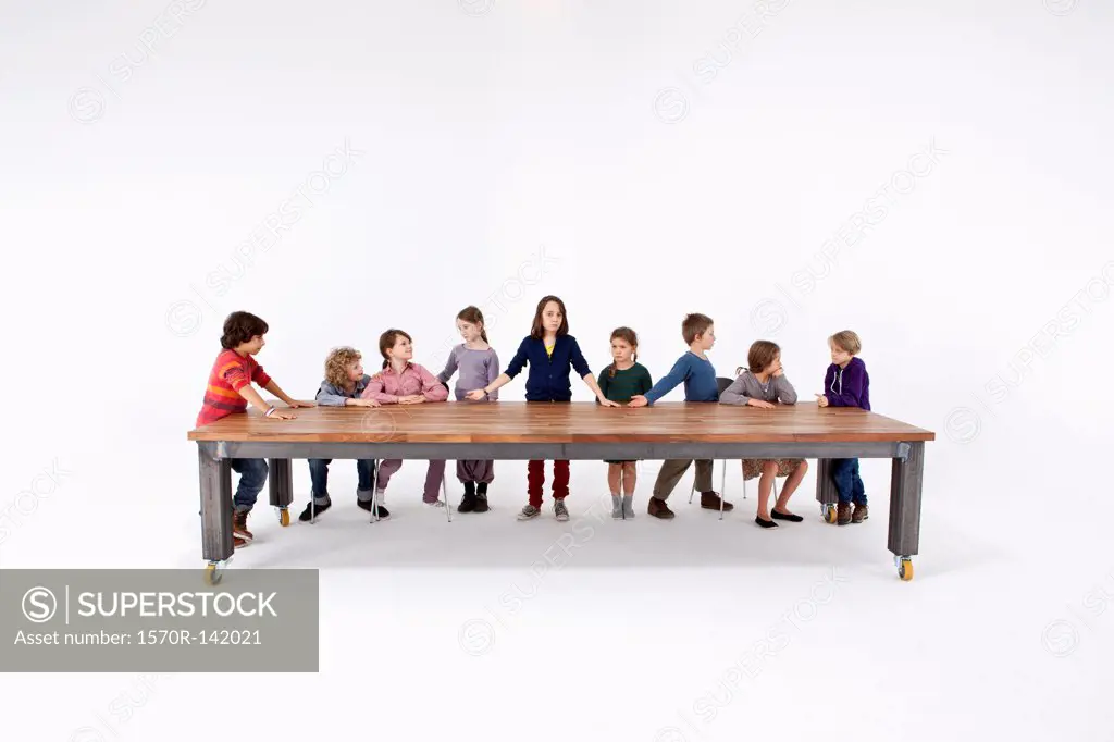 Nine kids arranged to imitate Leonardo Da Vinci's The Last Supper