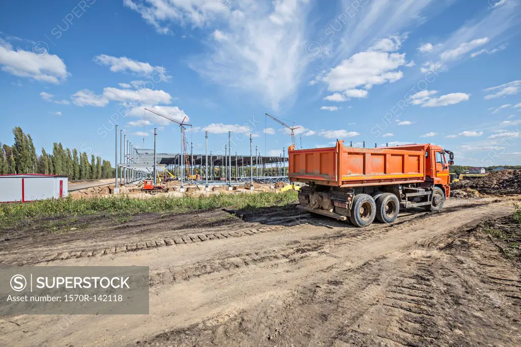 Dumper truck parked on dirt track at construction site