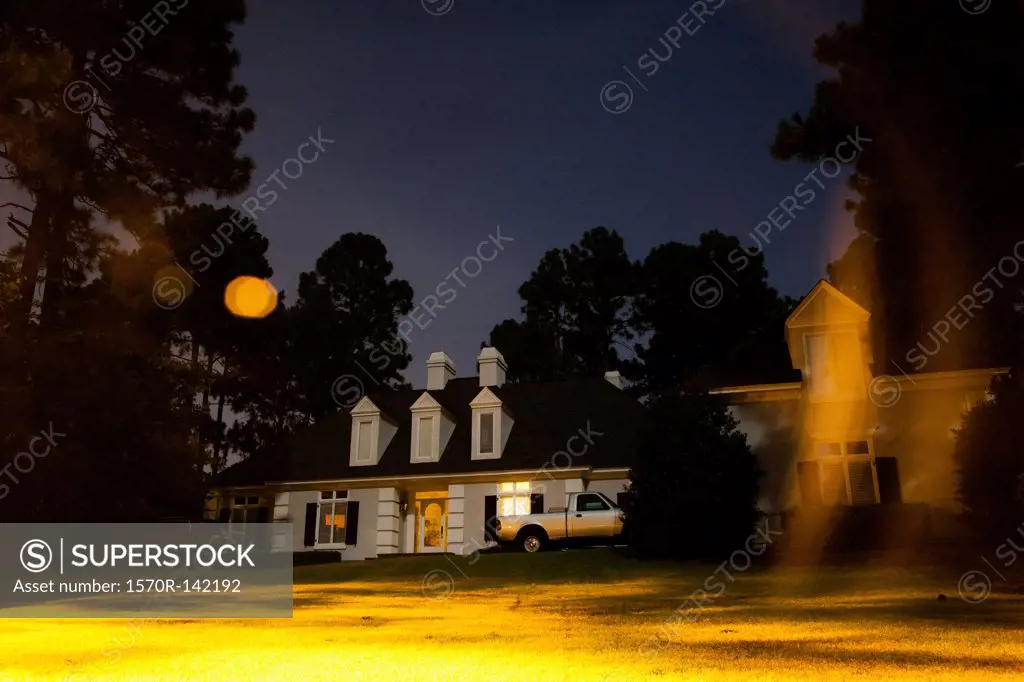 An illuminated house at night, long exposure