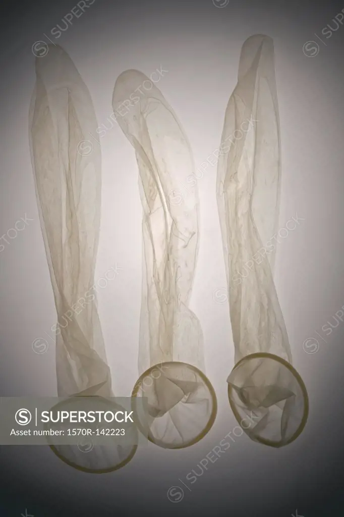 Three empty used condoms in a row, seen from above
