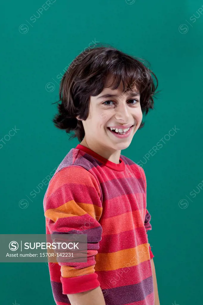 A cheerful preadolescent boy smiling at the camera