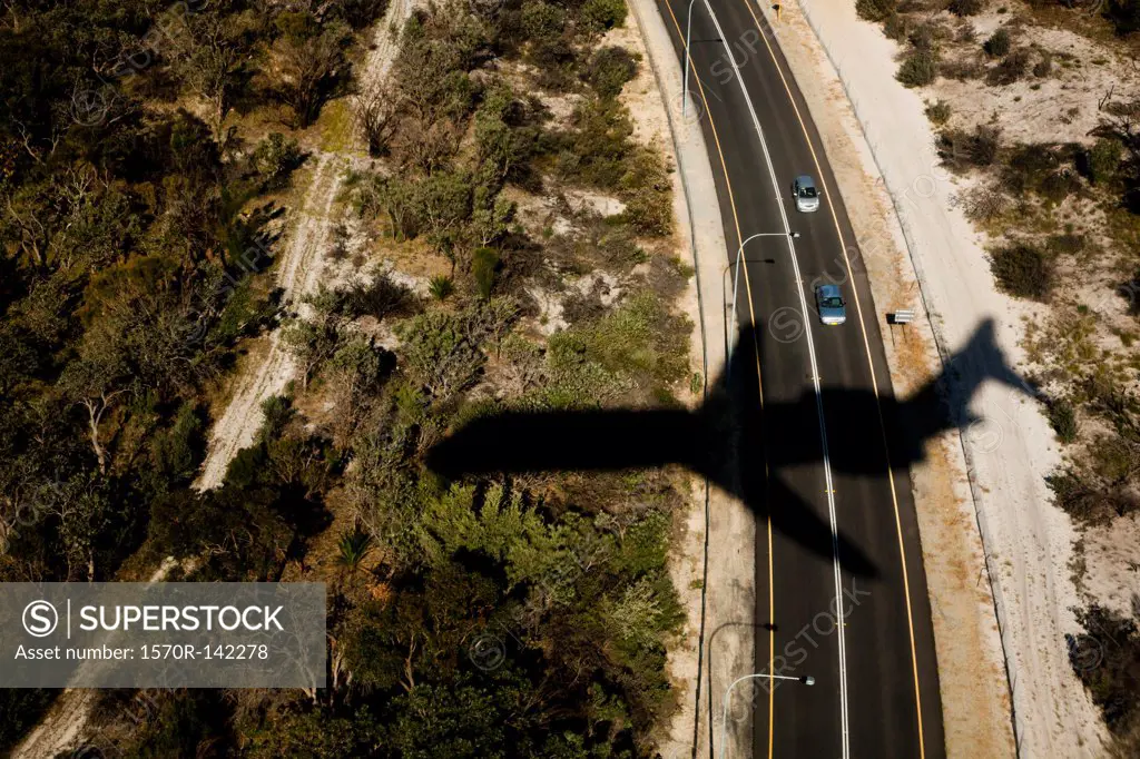 View of a highway and the shadow of a plane