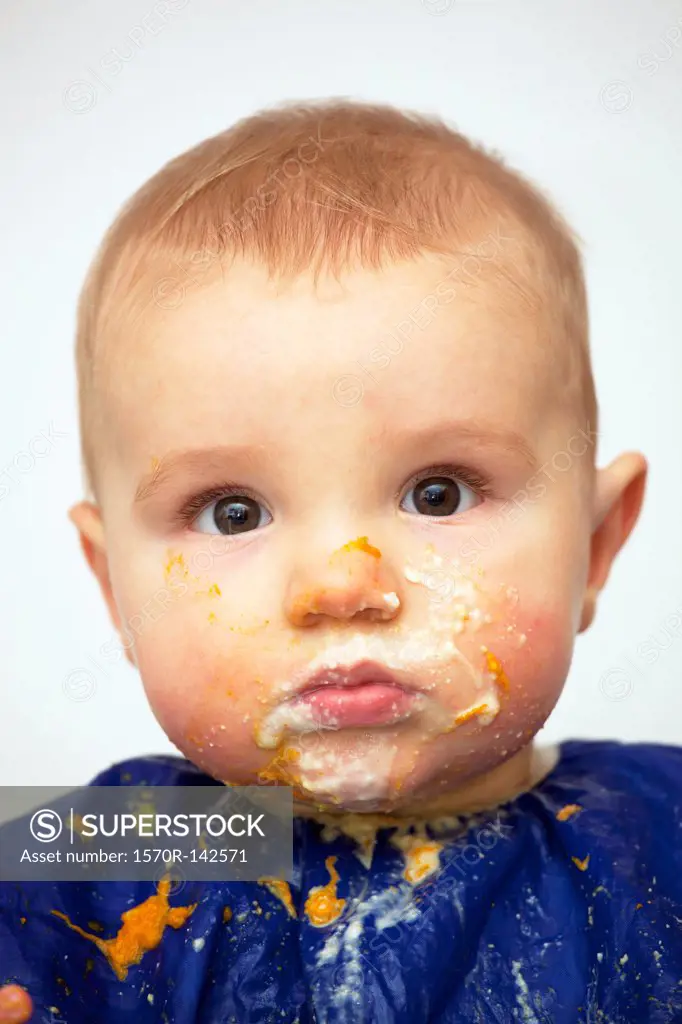 Portrait of a baby boy with food on his face