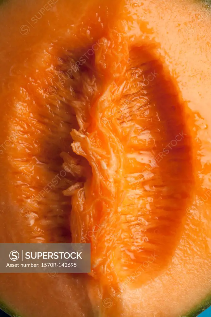 A juicy slice of cantaloupe that is suggestive of female genitalia