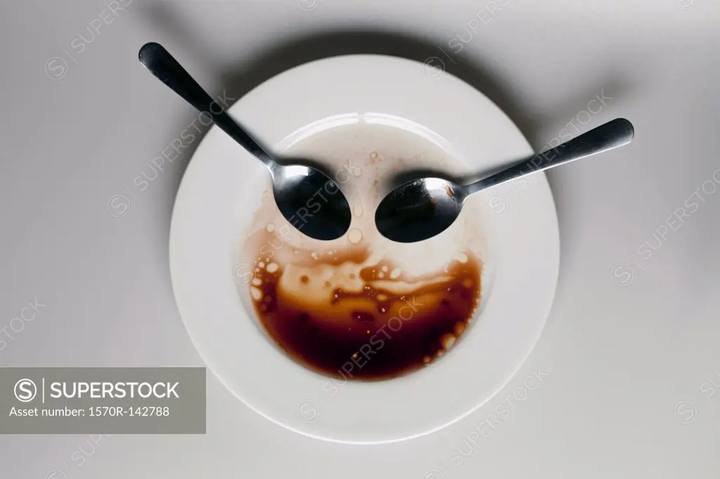 Abstract face made from spoons, plate and balsamic vinegar