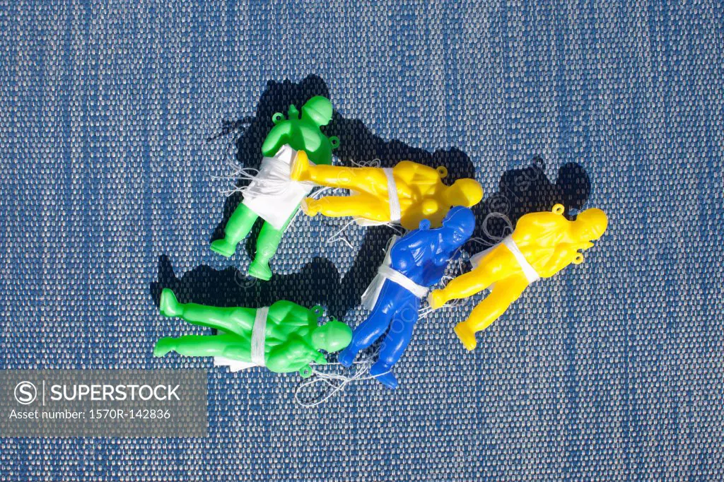 A collection of plastic toy paratroopers