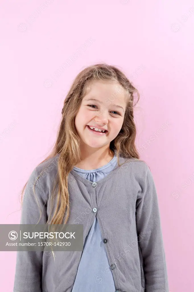 A girl grinning happily into the camera
