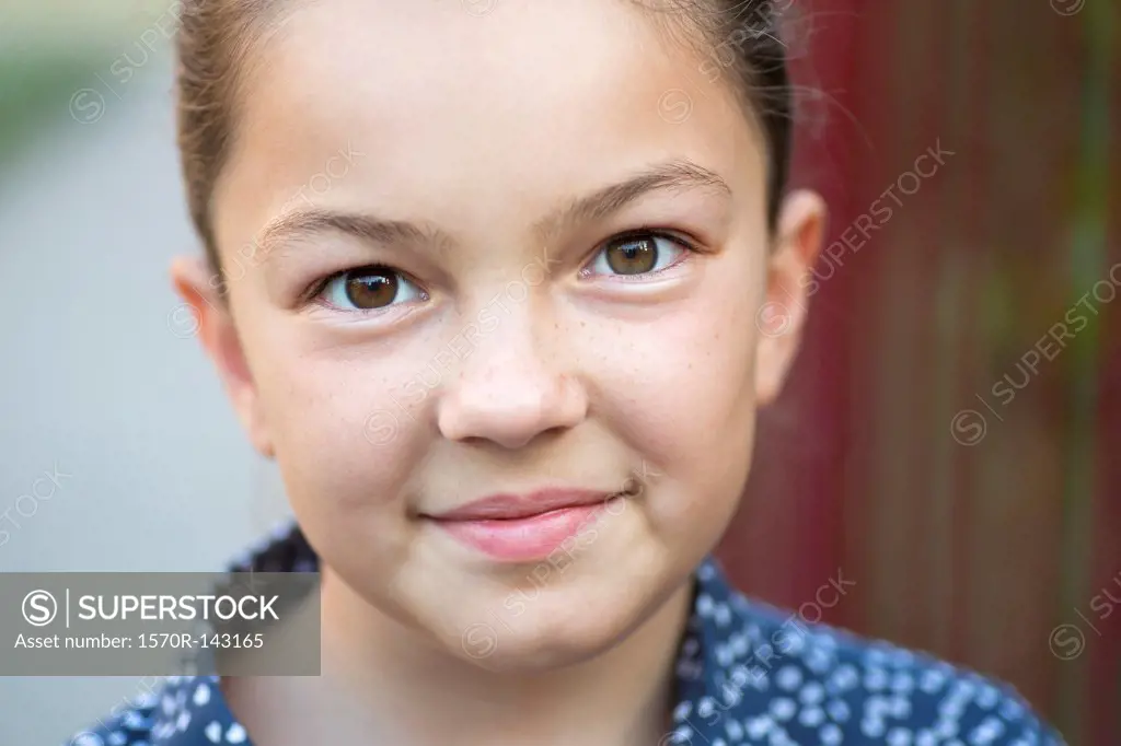 A girl smiling and looking into the camera