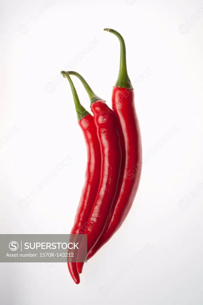 Three red chili peppers touching, in a row