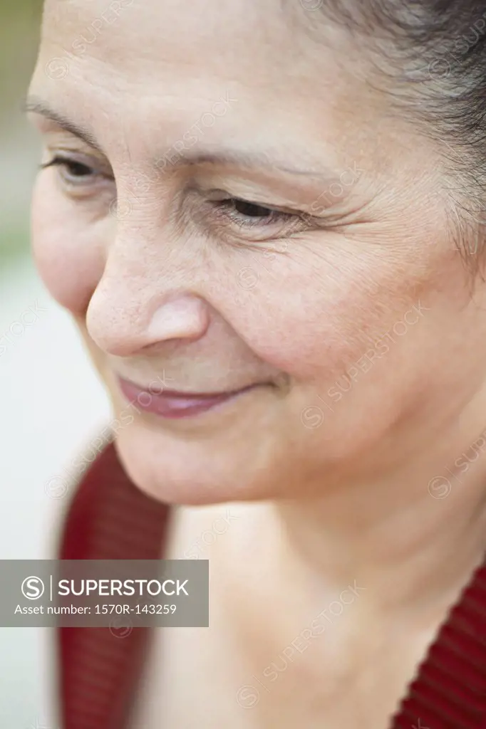 A mature woman looking away serenely