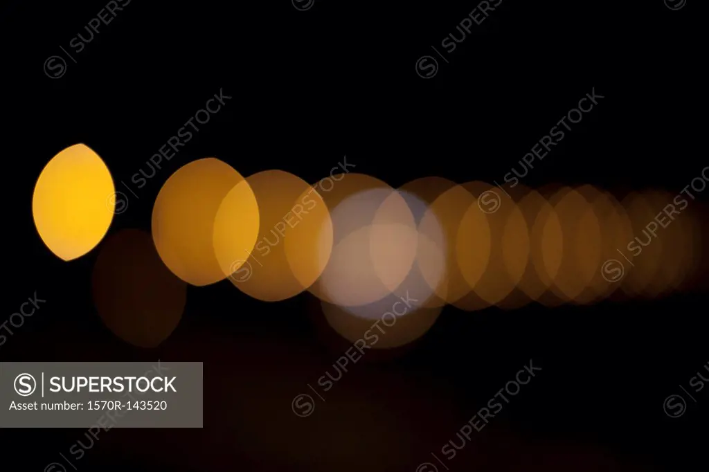 Orange circular light pattern against a black background