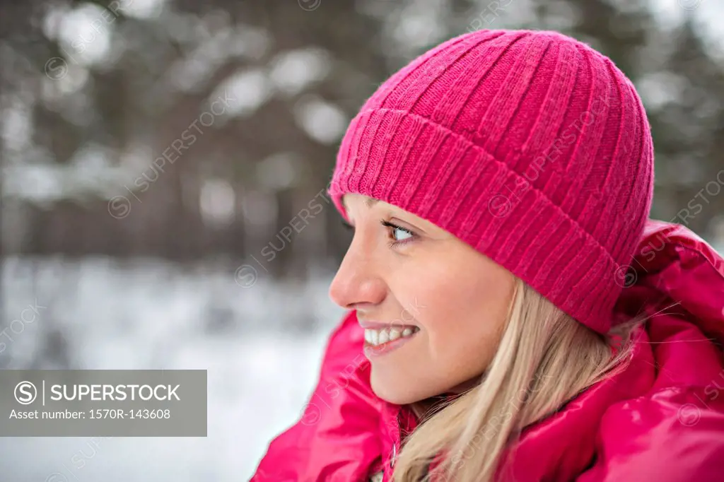 A woman wearing bright pink winter clothing outdoors