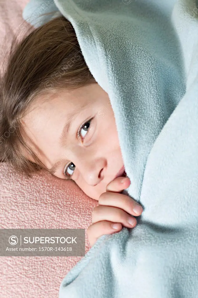 Girl under blanket