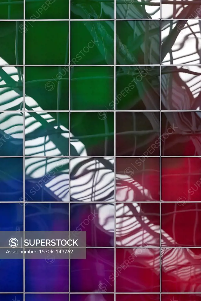A spectrum of colors reflecting in square glass windows, full frame