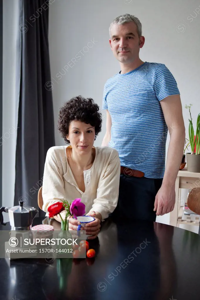 A serious hip mixed age couple at the breakfast table