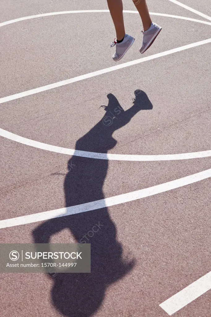 Shadow of man playing basketball