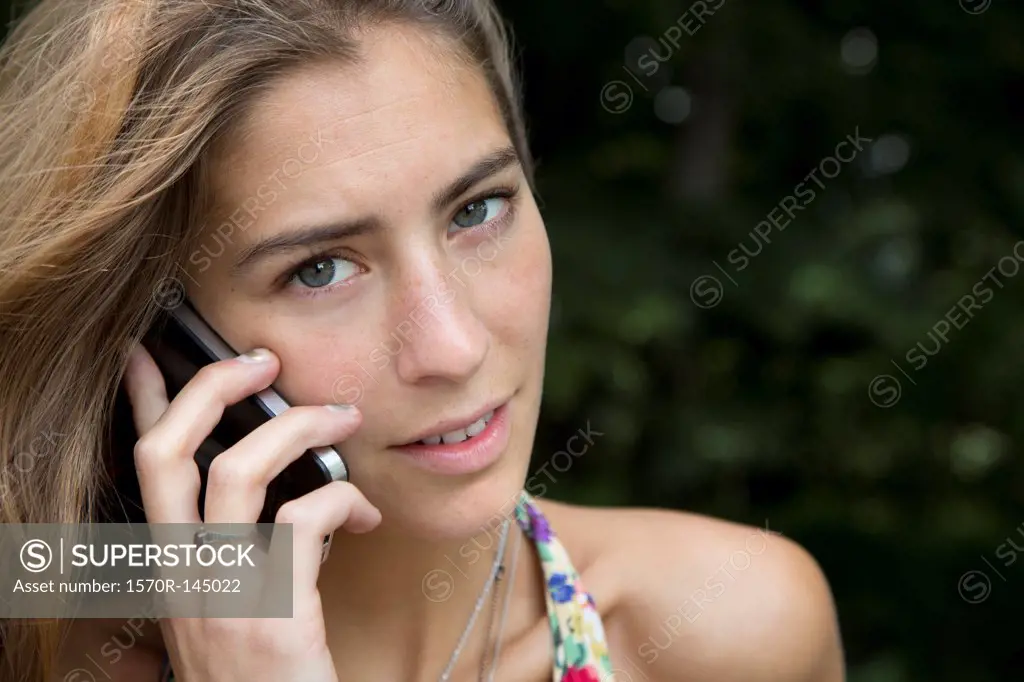 Young woman talking on mobile phone, close-up