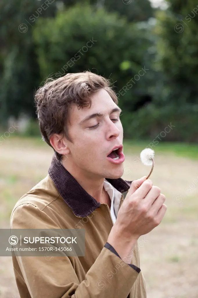 Man holding dandelion flower