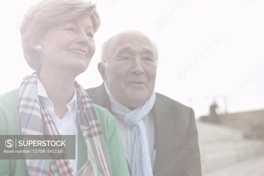 Couple looking away and smiling, close-up