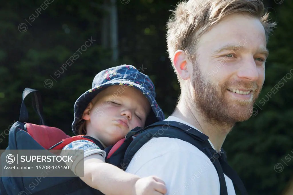 Father carrying his son in baby carrier