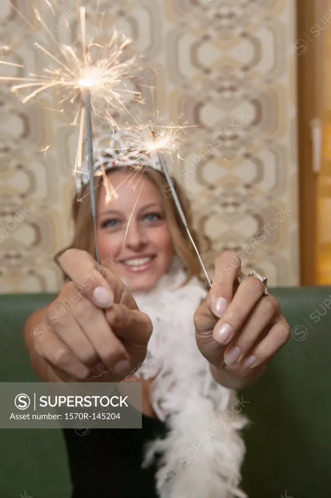 A woman holding sparklers