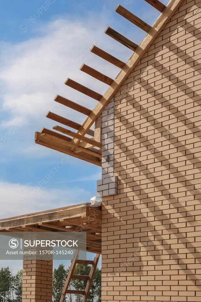House with wooden roof under construction