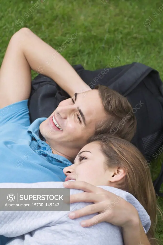 Young couple lying on grass