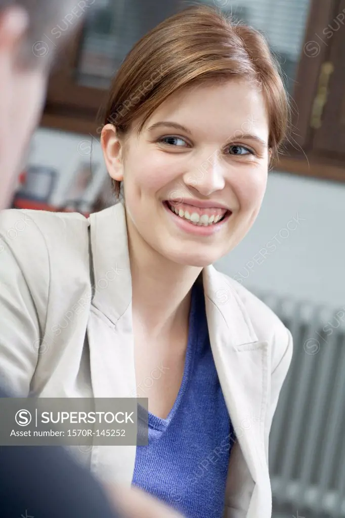 Young woman smiling and looking away, close-up