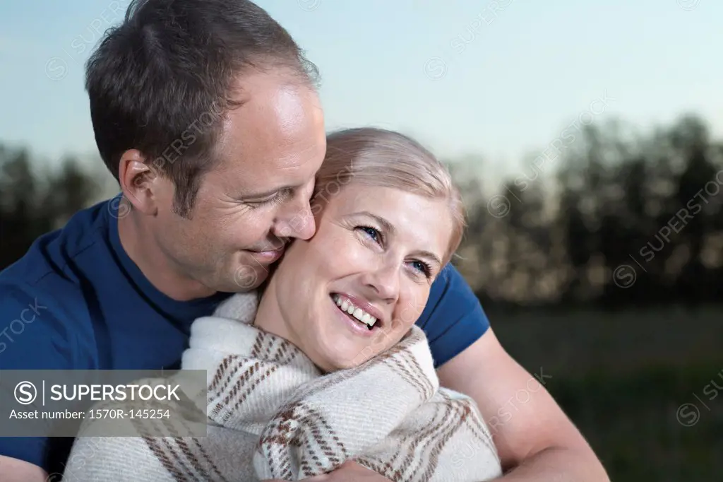 Mid adult couple smiling, close-up
