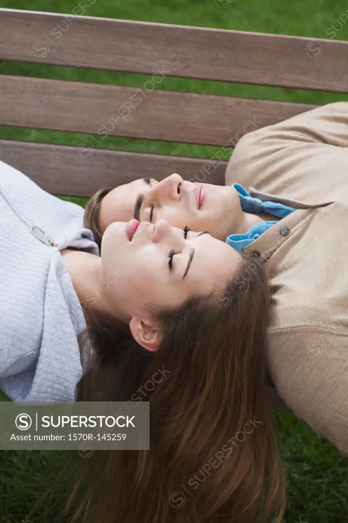 Young couple sleeping on bench