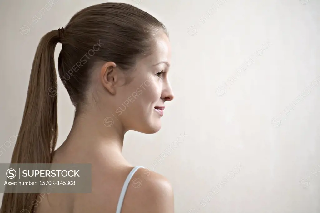 Young woman looking away, smiling