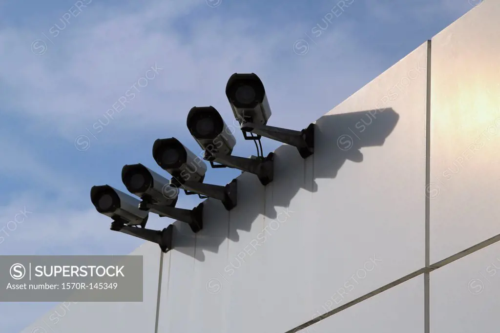 Surveillance cameras on wall, low angle view