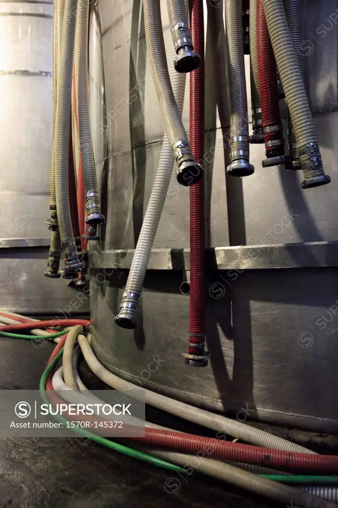 Pipes with connectors hanging on water tank