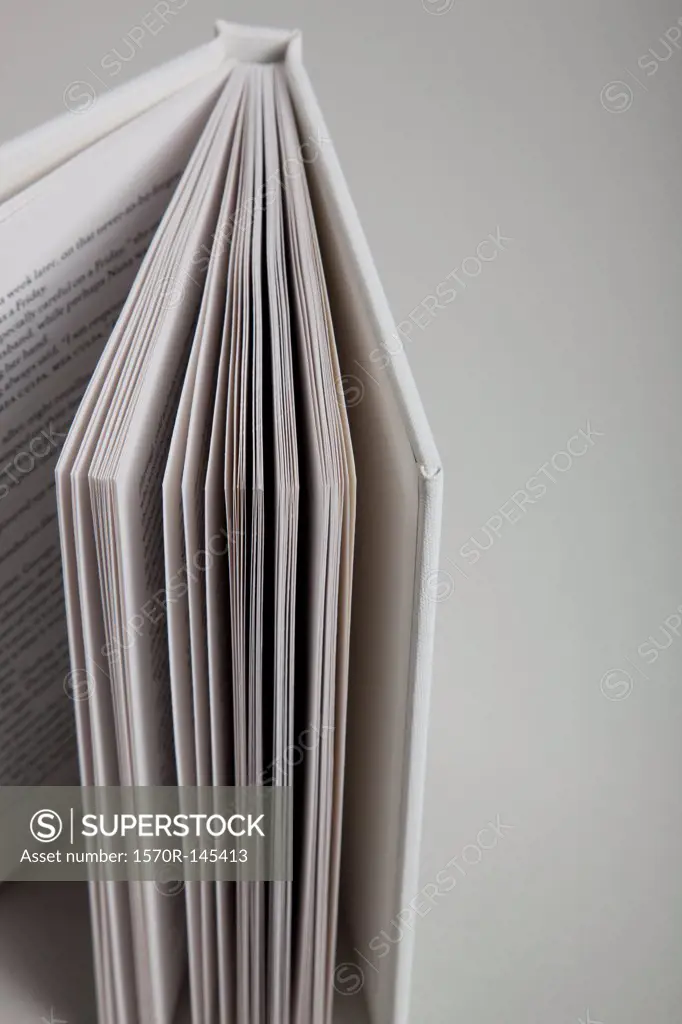 Open book on white background, close-up