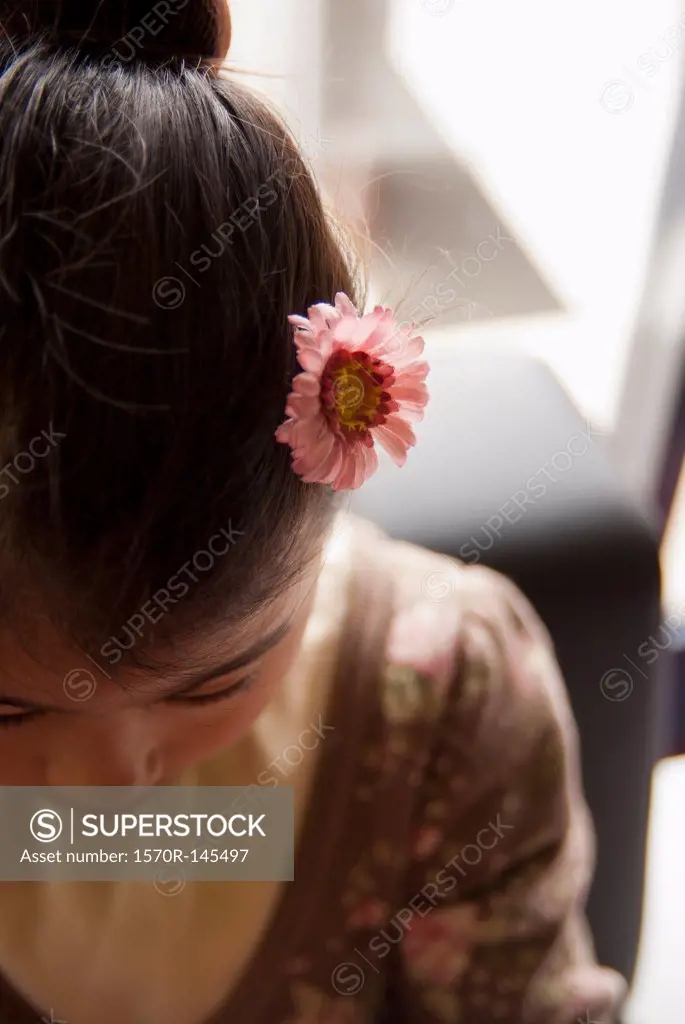 Teenage girl wearing flower in her hair, close-up
