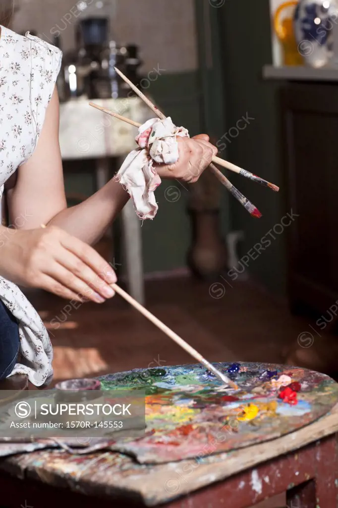Female artist using palette, close-up