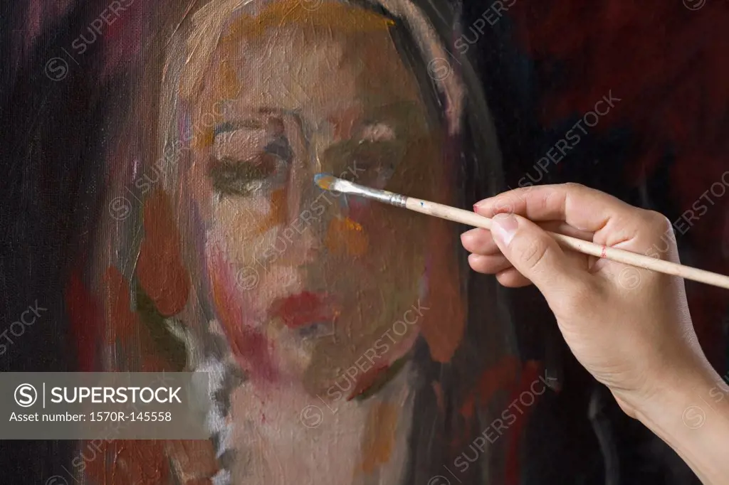 Female artist painting, close-up