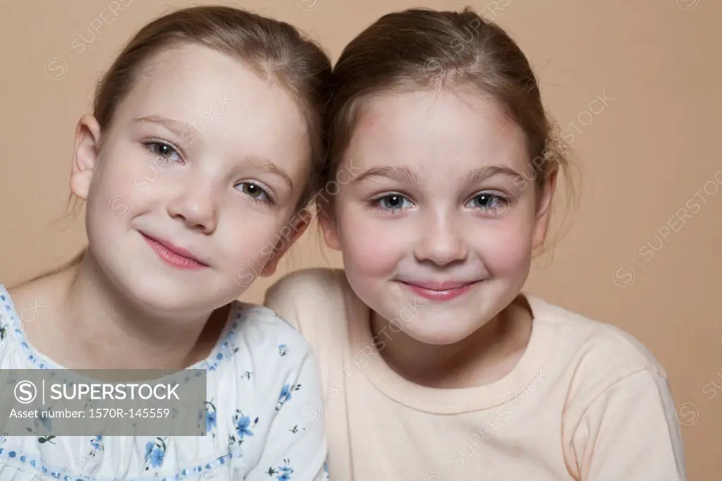 Portrait of two girls smiling, close-up