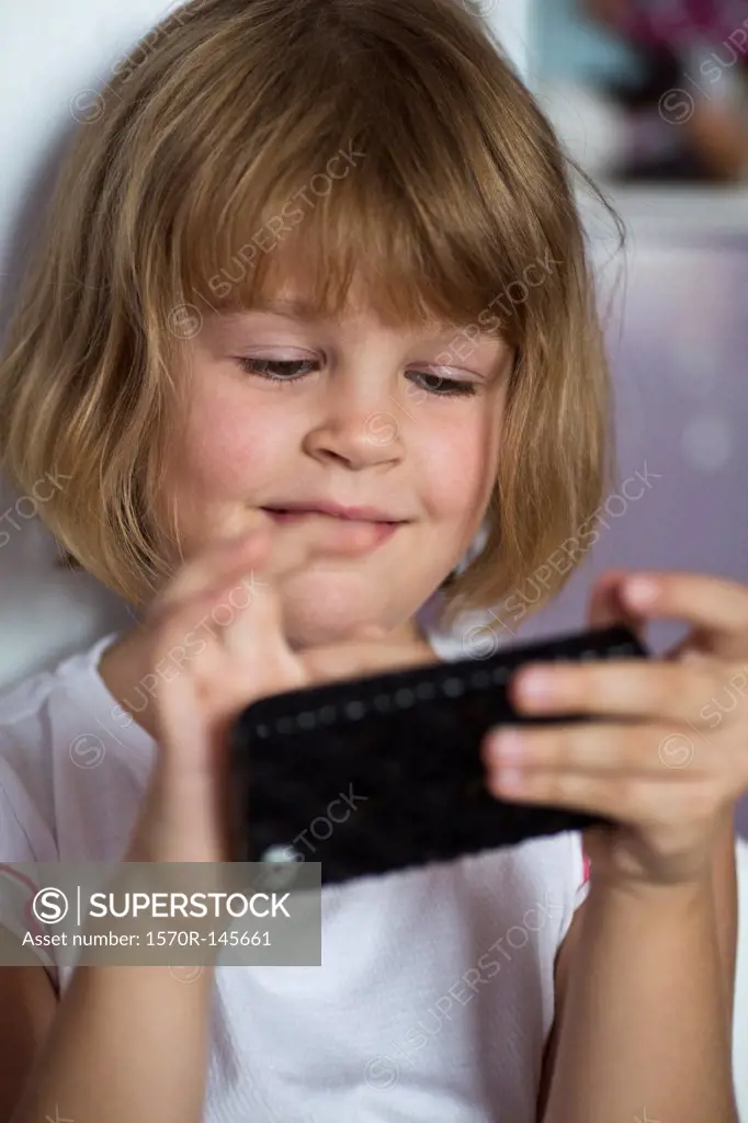 Girl playing on mobile phone, close-up