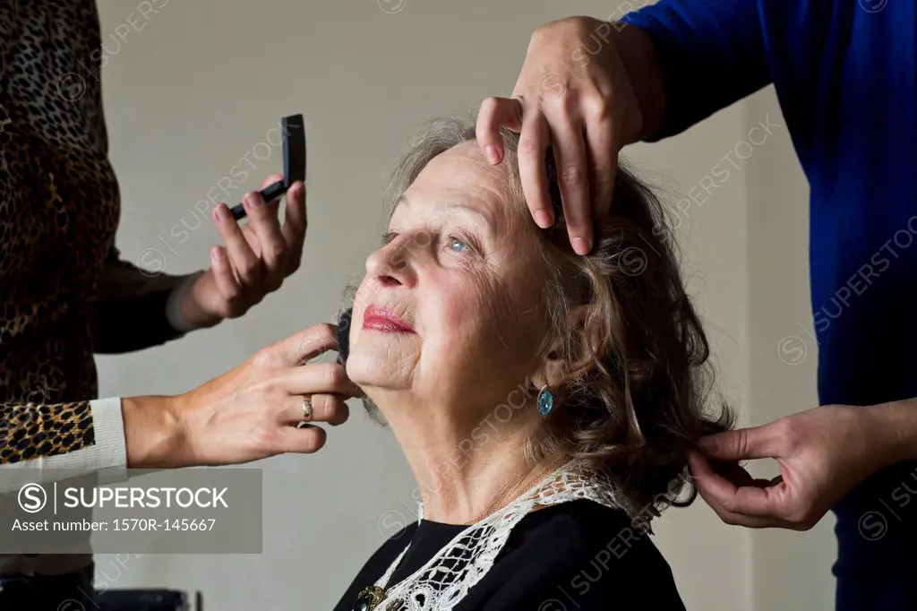 Makeup artist applying compact powder on woman face