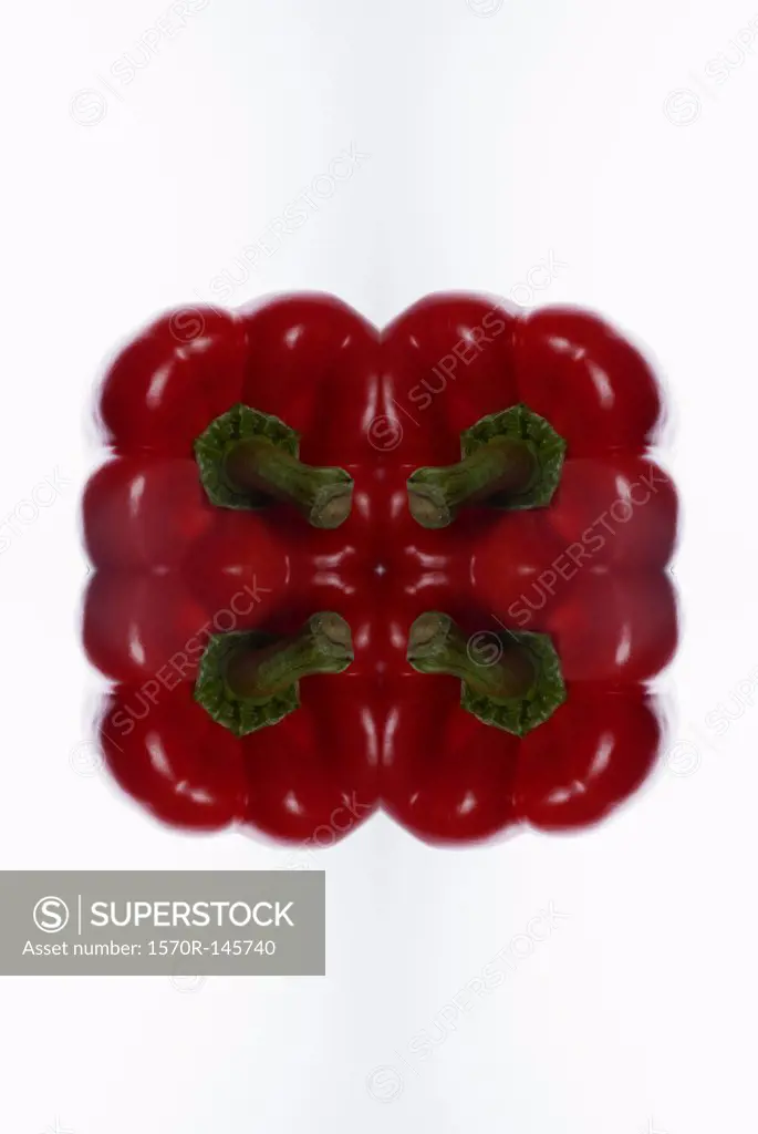 A digital composite of mirrored images of tops of red bell peppers