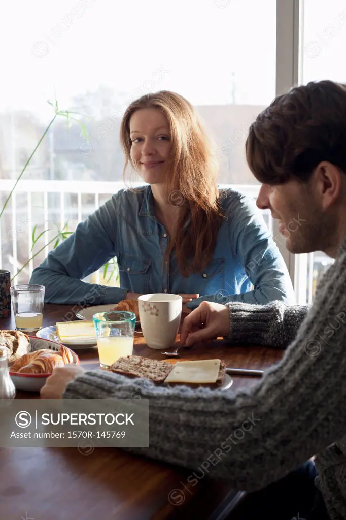 Couple having breakfast at dining table