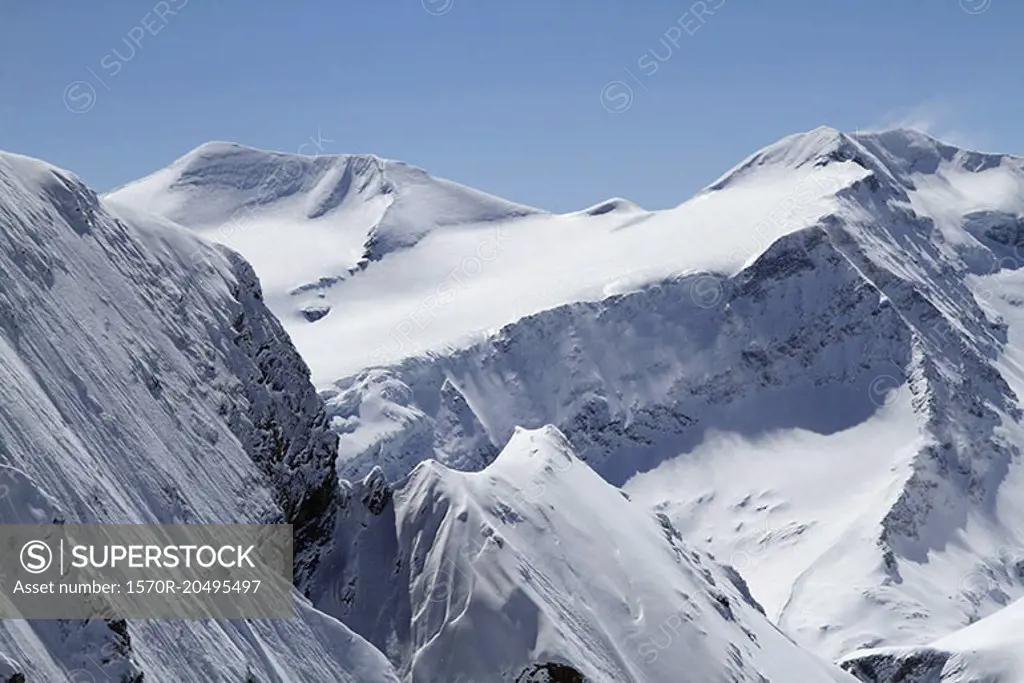 Snowcapped mountain against clear blue sky