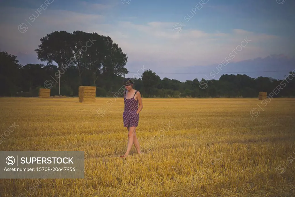 Woman walking on agricultural field